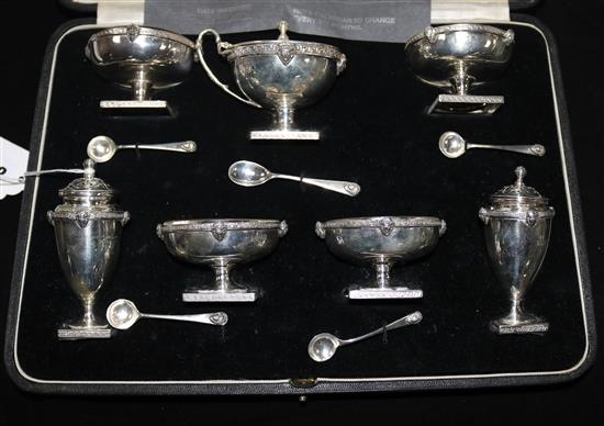 A cased matched seven piece silver condiment set by William Hutton & Sons.